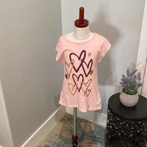 Adorable, pink tea with detail in the back in a little bit of a ruffle